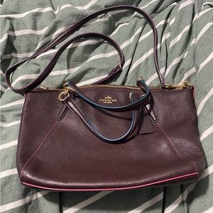 Medium sized cross body coach bag Soft leather Burgundy with pink and blue trim.